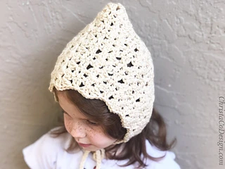 cream baby bonnet modeled by young girl