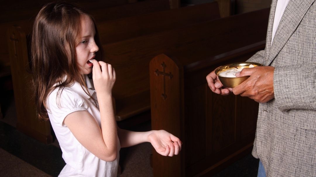 child taking communion during Holy Week 