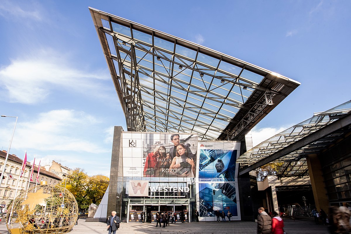 Entrance to the Westend Mall, decorated with advertising banners in Hungarian