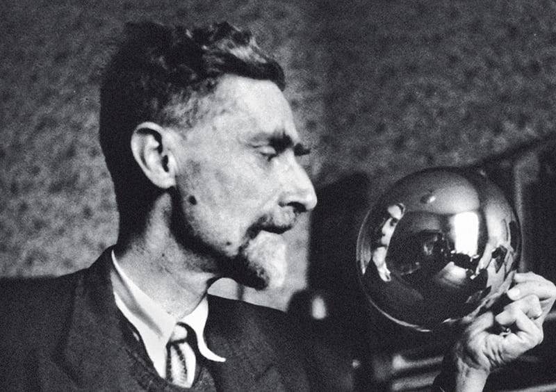 MC Escher with his famous mirror ball