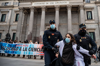 Police officers remove a climate activist of the Scientist Rebellion group from a protest in front of the Congress of Deputies in Madrid, Spain, on April 6, 2022.