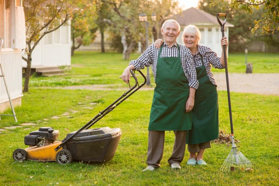 Mature couple outside doing yardwork