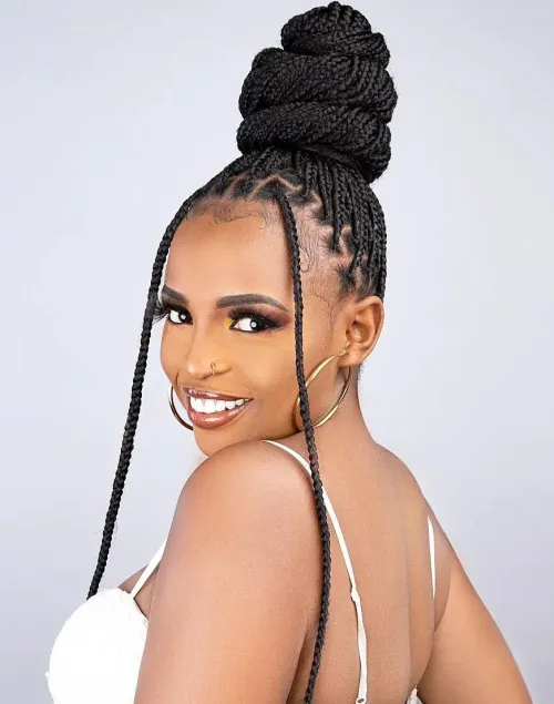 Full view of a lady rocking her small box braids in a bun 