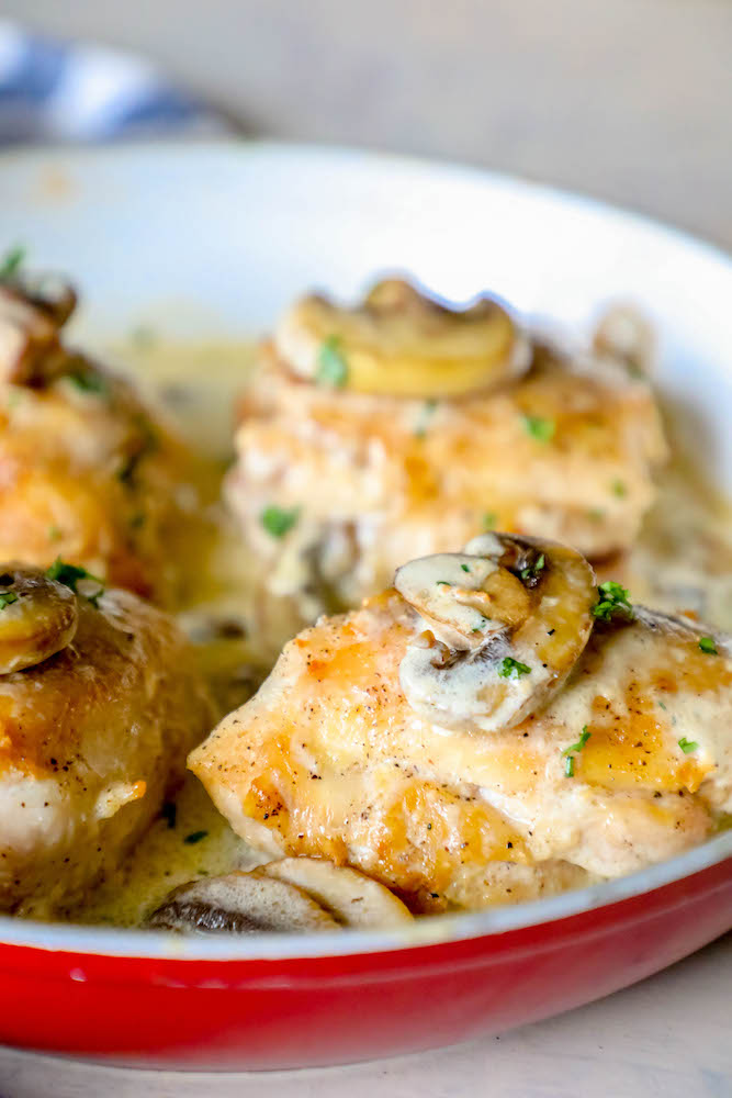 chicken thighs with mushrooms and a creamy garlic sauce in pan picture