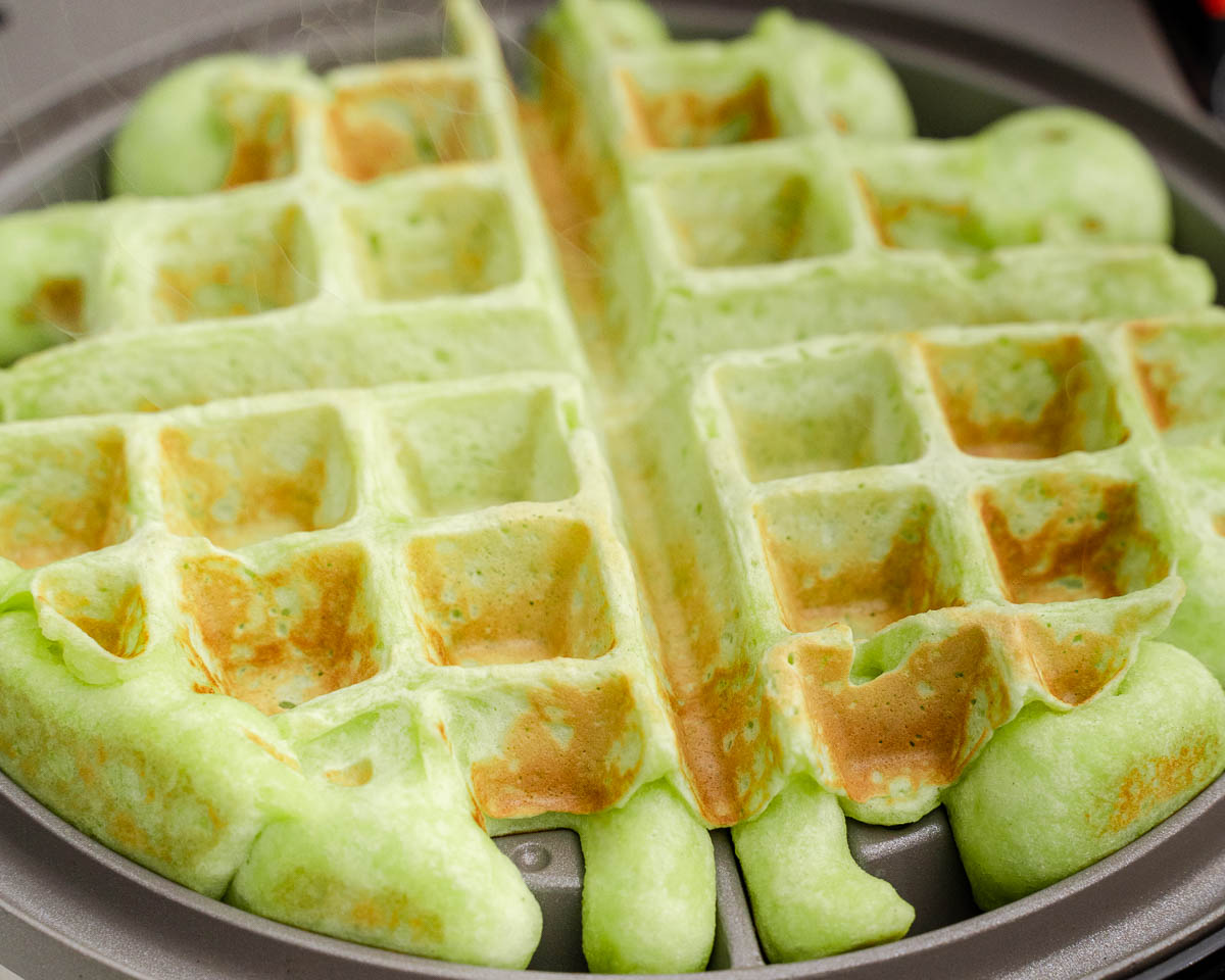 Christmas waffles cooking in waffle iron