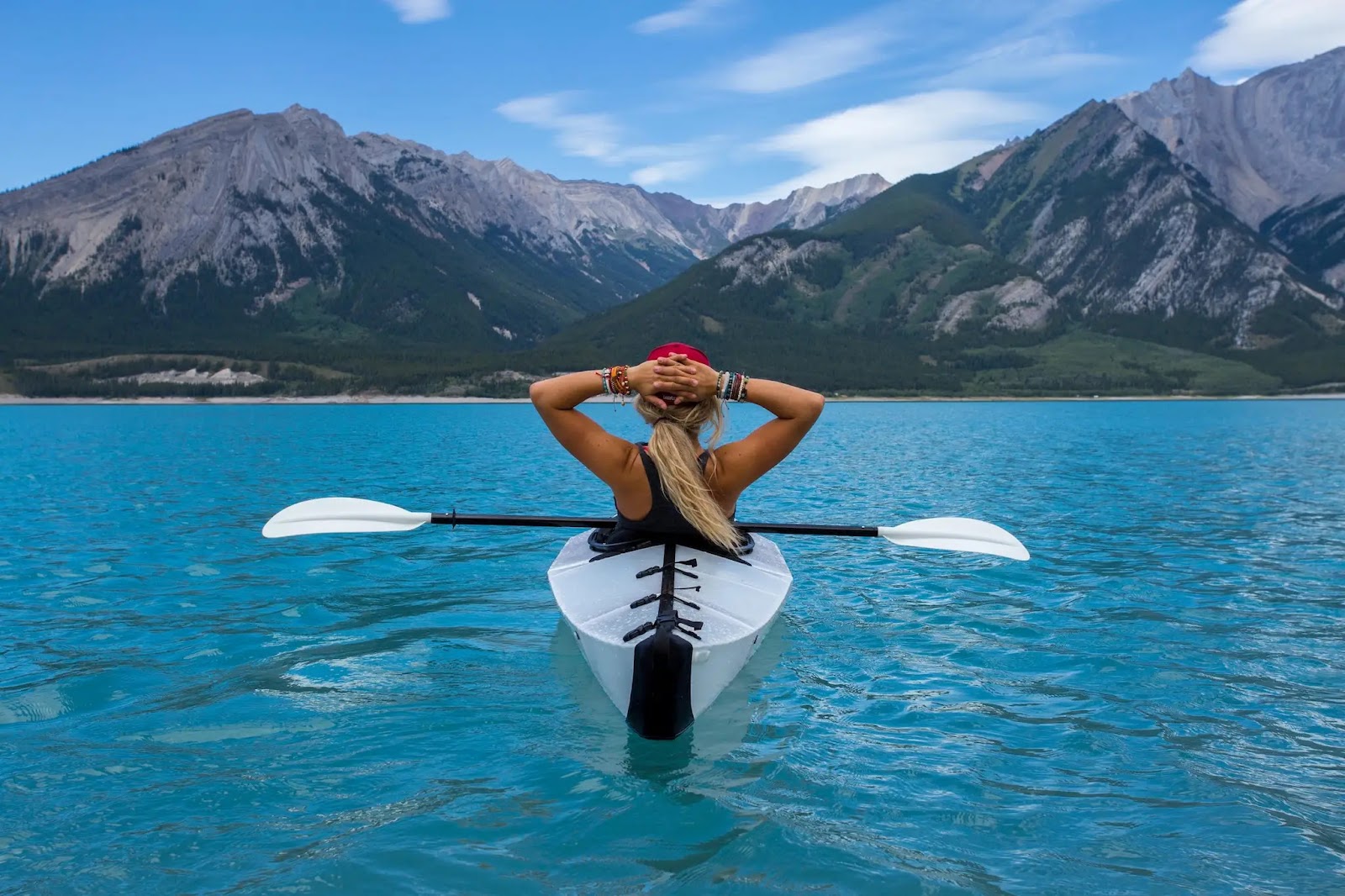 Woman in kayak on blue waters