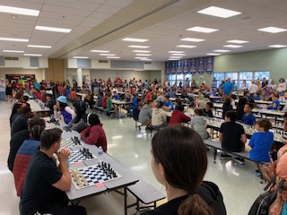 Students in the cafeteria engaging in the game of chess