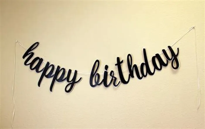 how to write happy birthday in cursive; a happy birthday decor on the wall 
