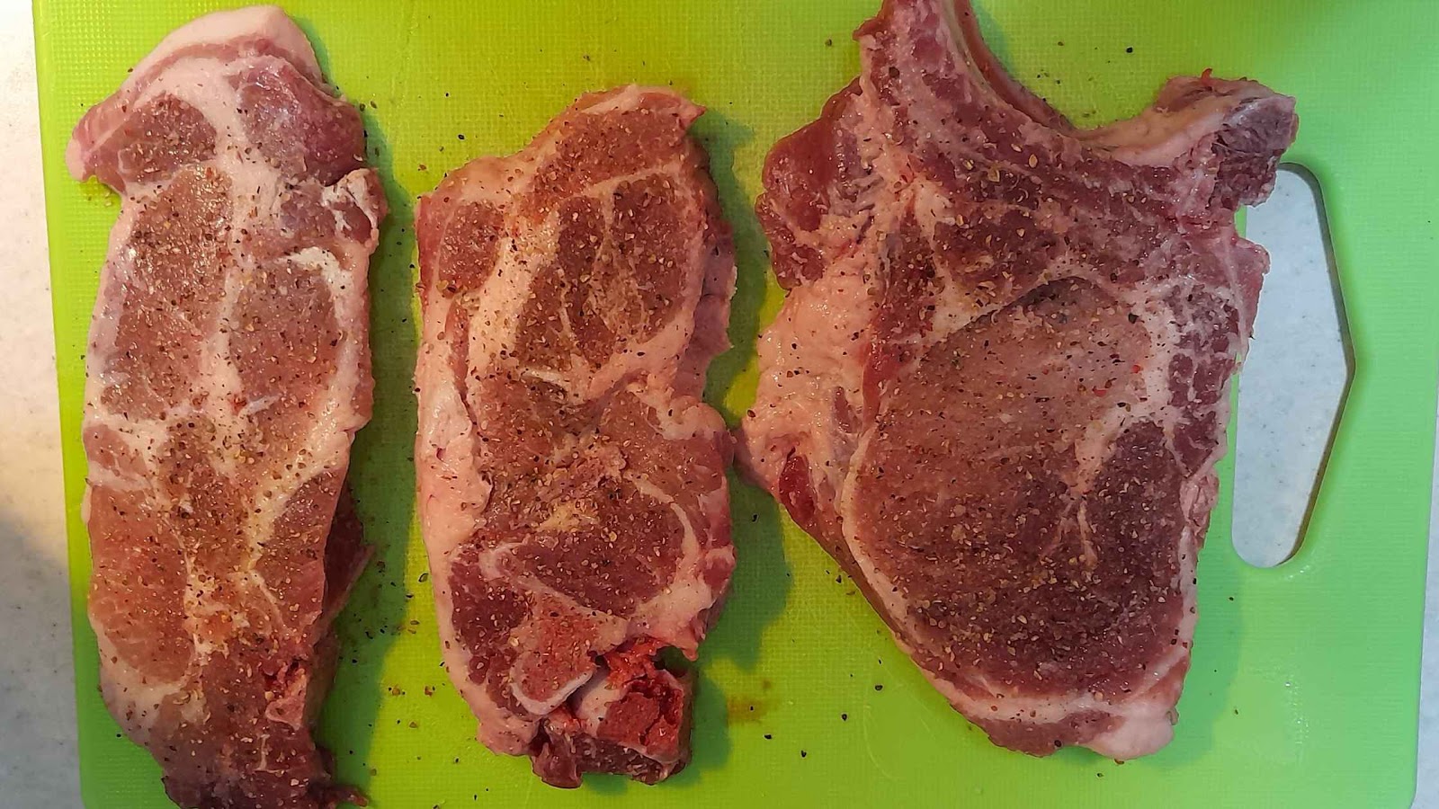Lightly seasoned steaks to be tested.