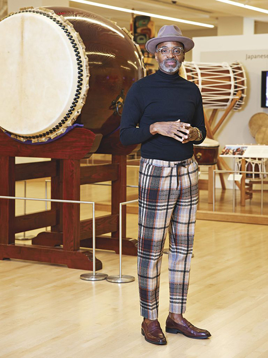 Paul Jeffrey, a furniture designer, poses in front of a section of drums at MIM for "Masters of the Southwest" article in Phoenix Home and Garden