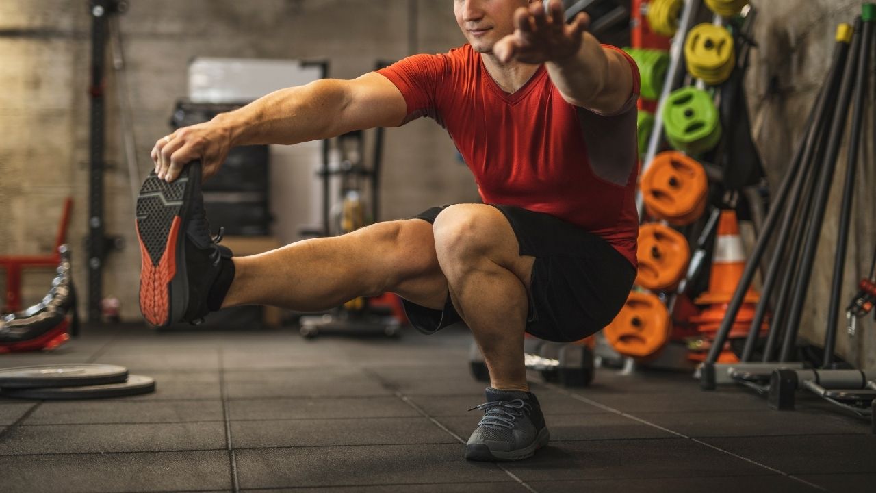 A man performs single-leg squats.