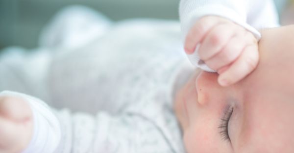 baby rubs face and wakes up