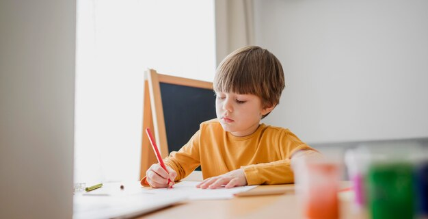 A little kid writing on a paper