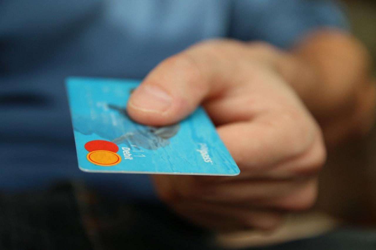 A person holding a debit cards