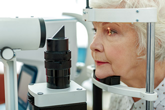 elderly woman getting an eye exam