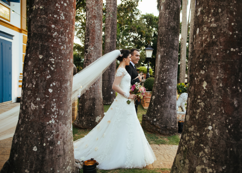 A bride and her father walking down the aisle during an outdoor wedding