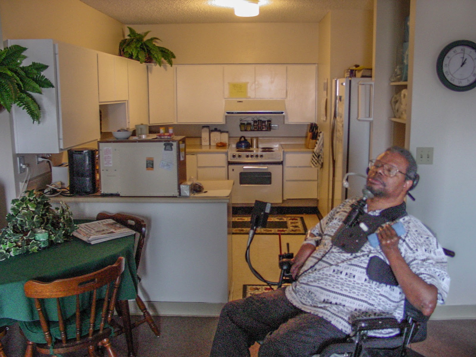Man using a power wheelchair in an apartment
