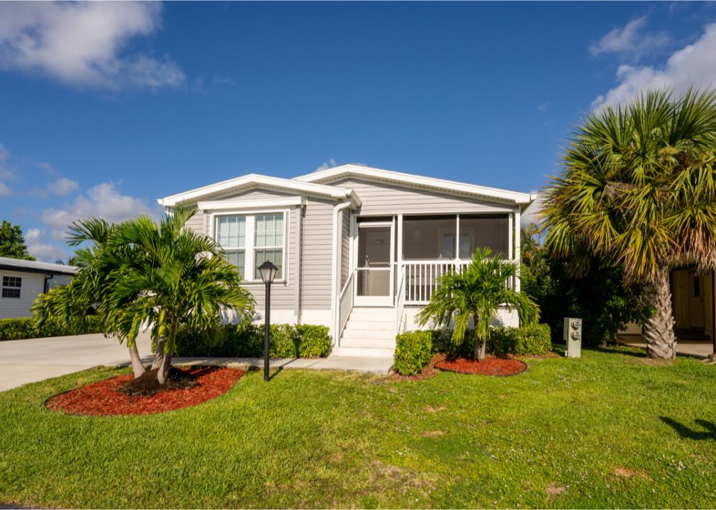 Manufactured home with palm trees.