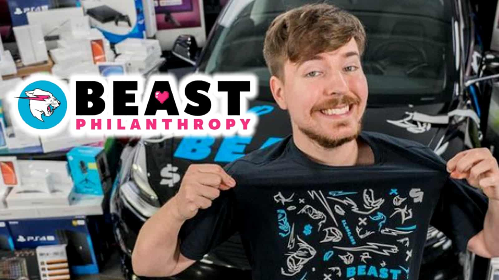 A picture of Jimmy Donaldson, AKA Mr Beast, smiling and showing off one of his merch designs - a black top with white and blue designs in the centre. The logo for his charity, Beast Philanthropy, is to the left of his head.