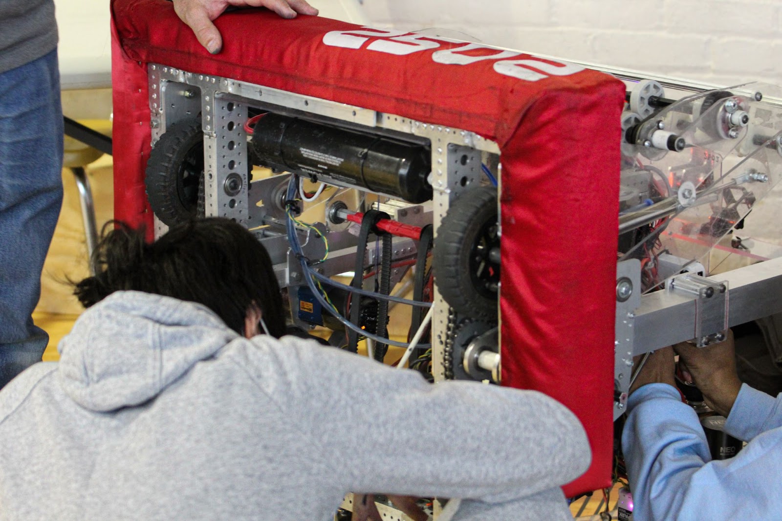 two student working on a drive train.