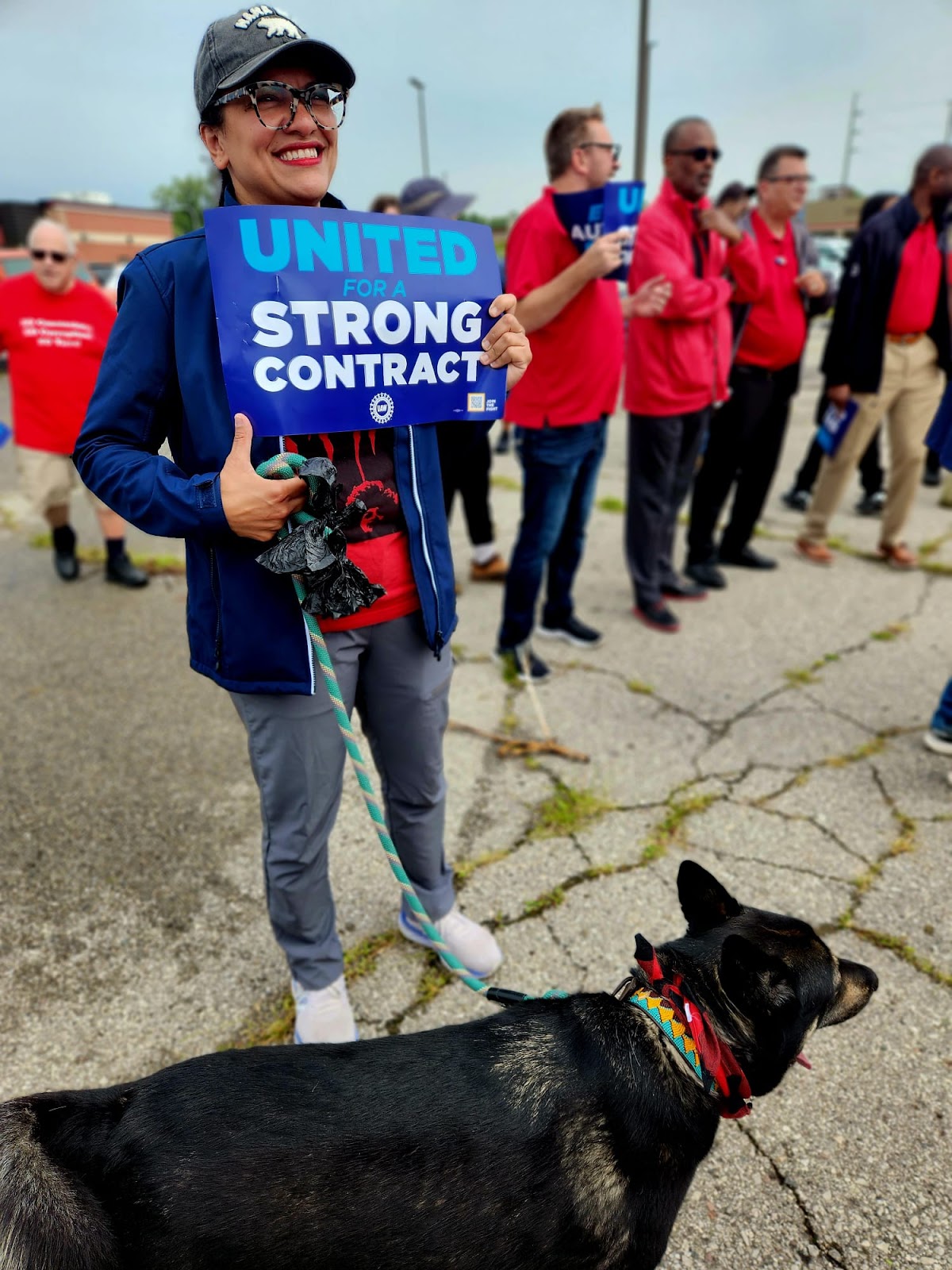 Rashida and her dog on the picket line with UAW workers