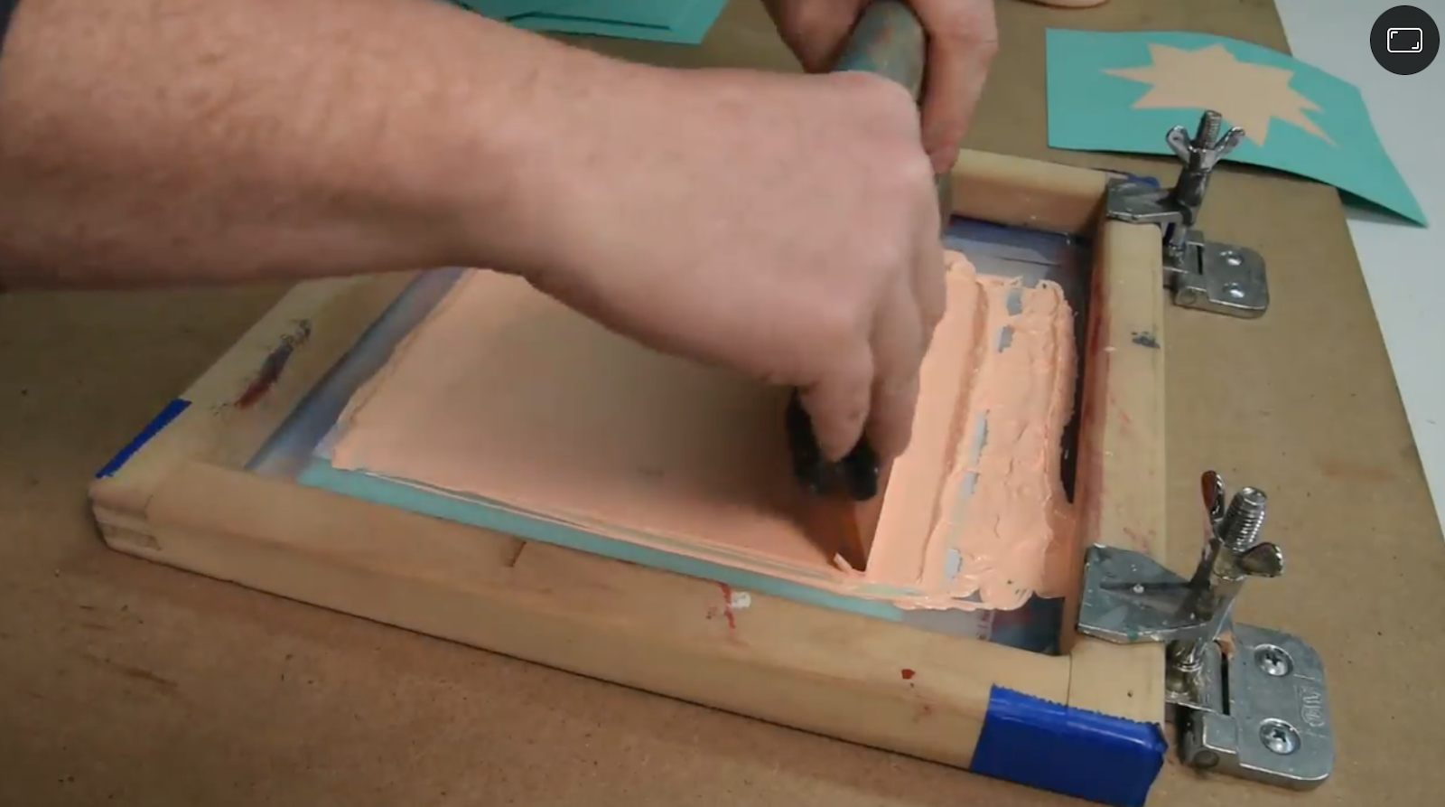 Here, screen printing is used to add an ink design on top of a piece of MDF. 
