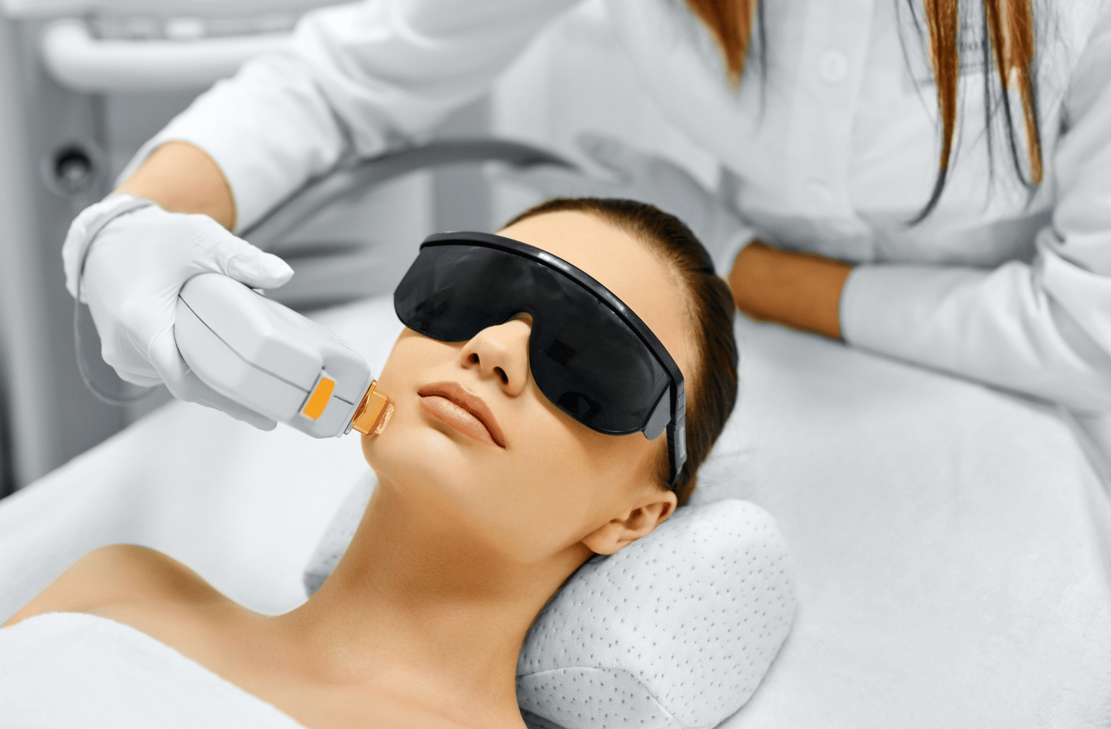 A woman receiving intense pulsed light therapy which can also help treat dry eye symptoms