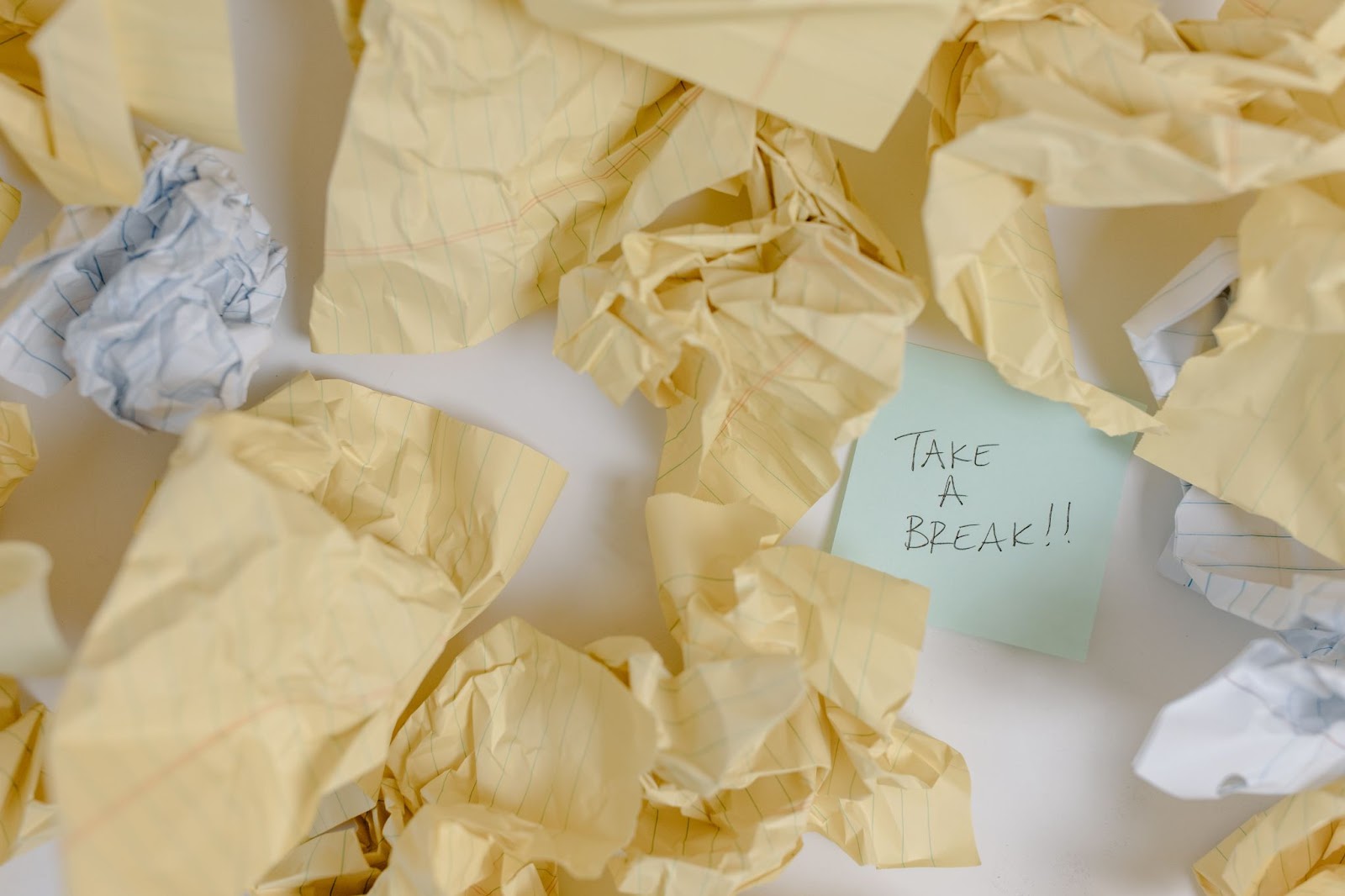 crumpled papers and sticky notes, one saying "take a break!!"