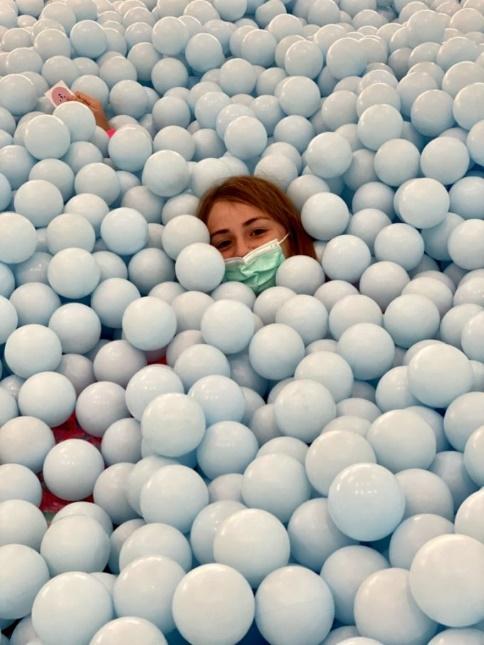 A person surrounded by white balls

Description automatically generated with medium confidence