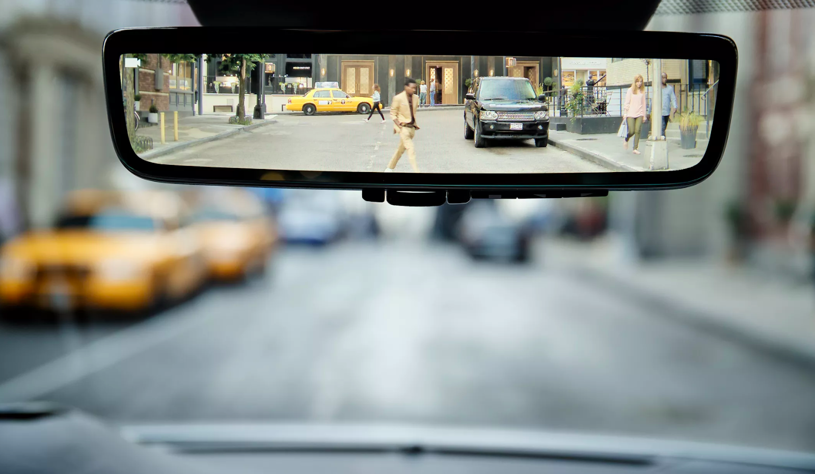 A view of what we see in the rear-view mirror of an automobile.