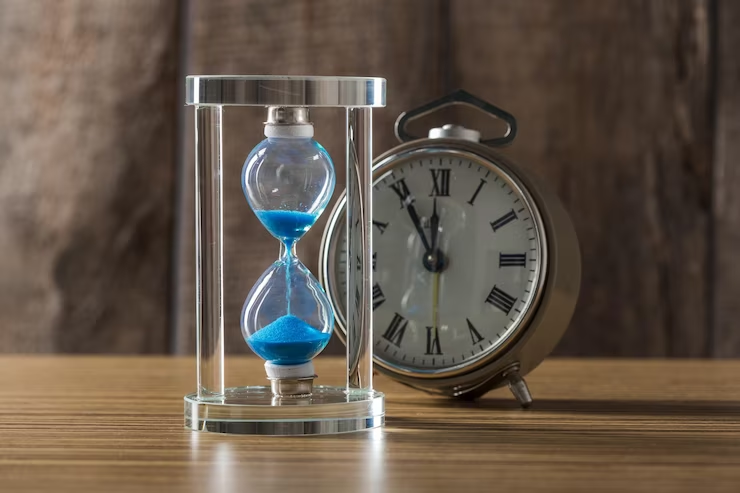 Close-up of a blue hourglass, symbolizing the passing of time.