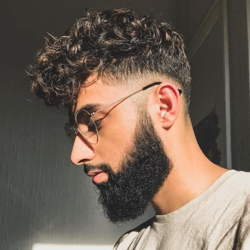 a bespectacled guy rocking broccoli haircut