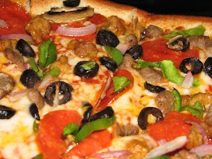 What toppings do you notice on this image of a pizza?