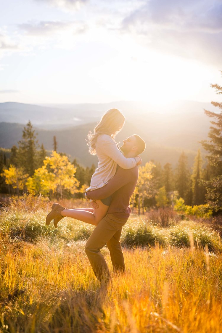A couple posing outside in the natural light during the golden hour 