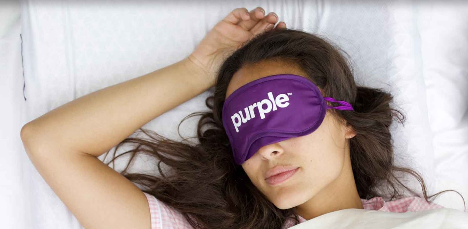 woman sleeping with purple sleep mask