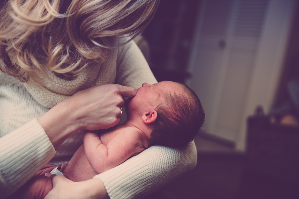 Mother holding baby - How to secure your family’s financial future