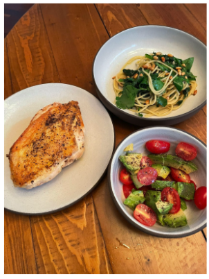 JDM's winning dish of the Chopped competition: spaghetti with a garlic, spinach, and parsley sauce topped with toasted pine nuts; paired with seared chicken breast seasoned with salt & pepper; and a side salad of avocado, cherry tomatoes, olive oil, salt, and pepper.