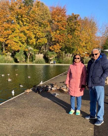 A person and person standing next to a pond with ducks in it

Description automatically generated with medium confidence