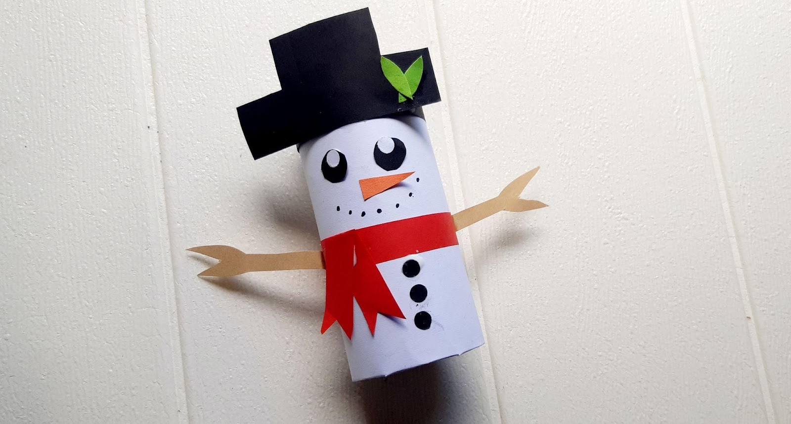 full toilet paper roll snowman craft close up with red scarf