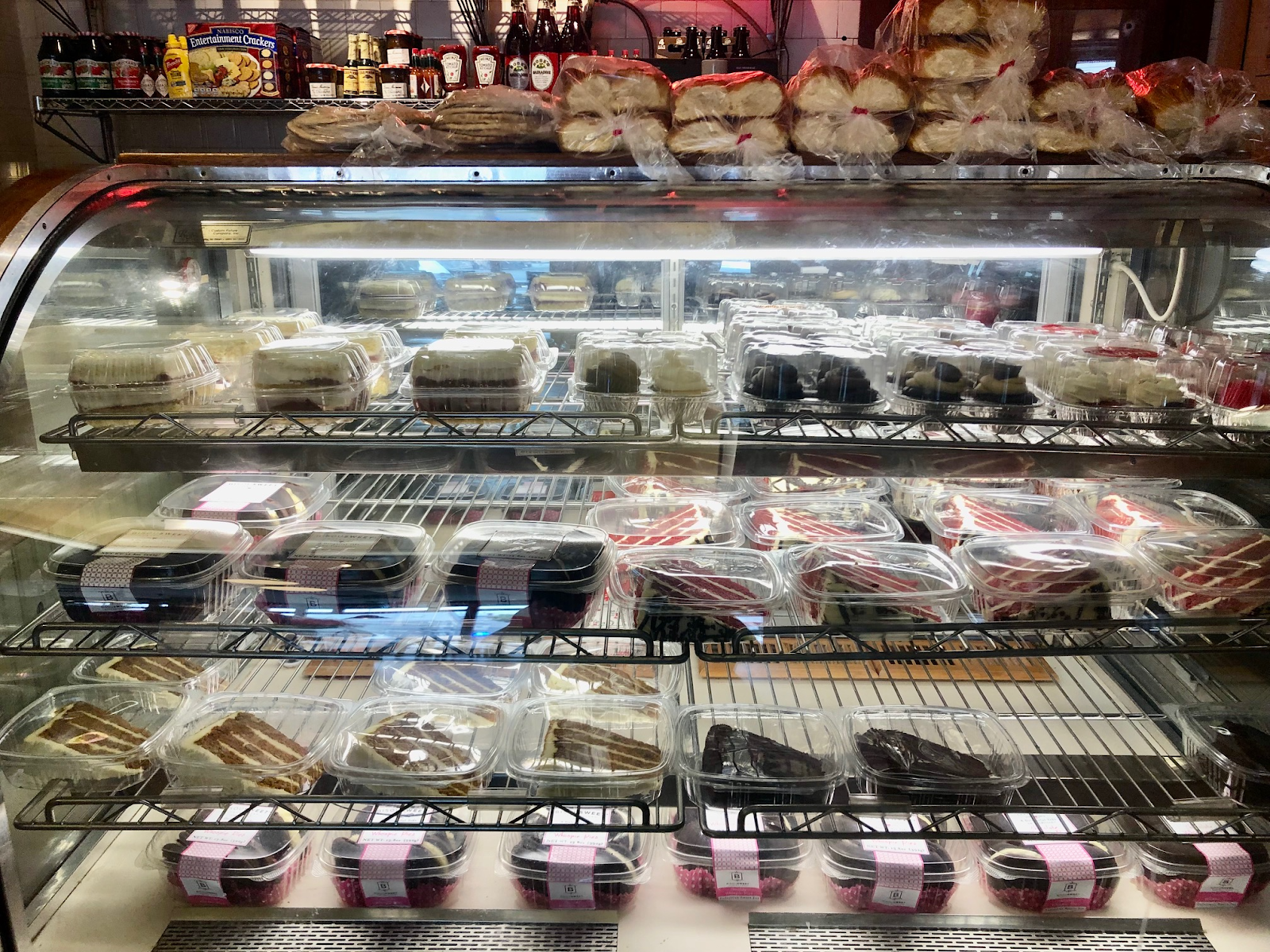 Clear case with four rows of prepared foods in clear containers