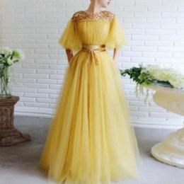 A person wearing a yellow dress

Description automatically generated with medium confidence