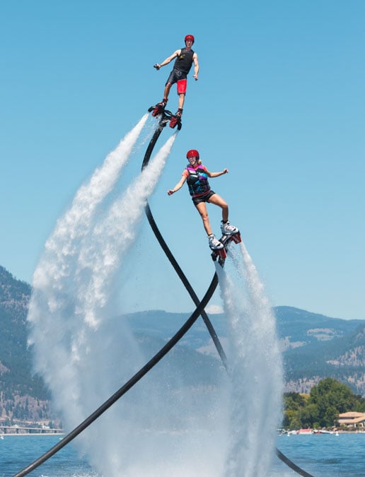 two people flyboarding over Okanagan lake in Kelowna