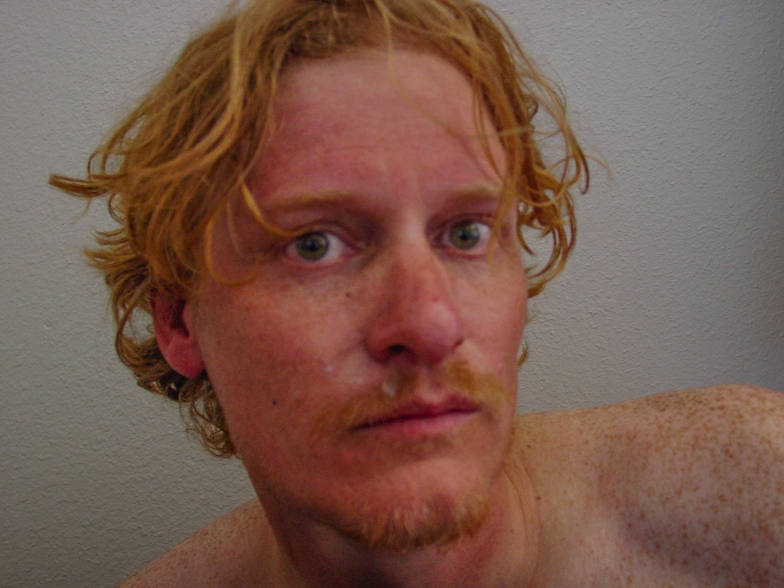 A photo of the author with disheveled hair and sunburned face. 