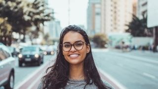 a-women-standing-walking-on-the-road-had-a-smiling-face