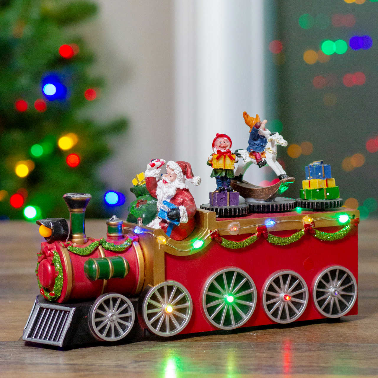 colorful tabletop ceramic train with Santa engineer