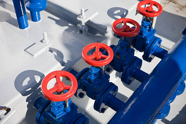 Red Safety Valves Series of red safety valves on blue industrial pipes. "safety valves" stock pictures, royalty-free photos & images
