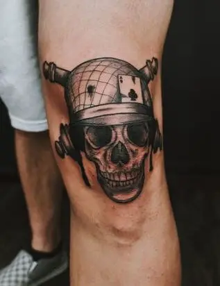 A picture of guy rocking the skull knee cap tattoo