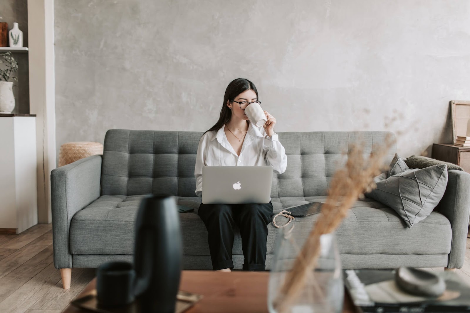 Woman typing on her laptop on her couch