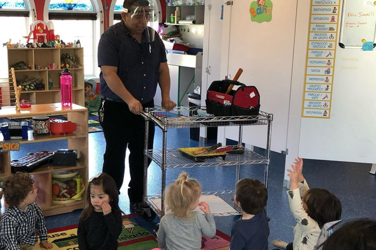 Pablo, casa employee showing children what different tools do.