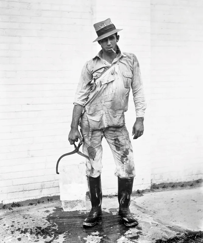 A deliveryman for the Home Ice Company hauls a 25-pound ice block cleaved  from a 100-pound block, 1928. Houston, Texas (Photo courtesy of the Sloane  Gallery): houston